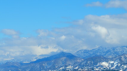 Snowy Fairy Tale Mountains With Blue Sky And Opposite Direction Clouds. Sunny Winter Day. Timelapse.