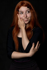 Obraz premium portrait photographs of a beautiful redhead woman on black background