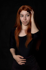 Fototapeta premium portrait photographs of a beautiful redhead woman on black background