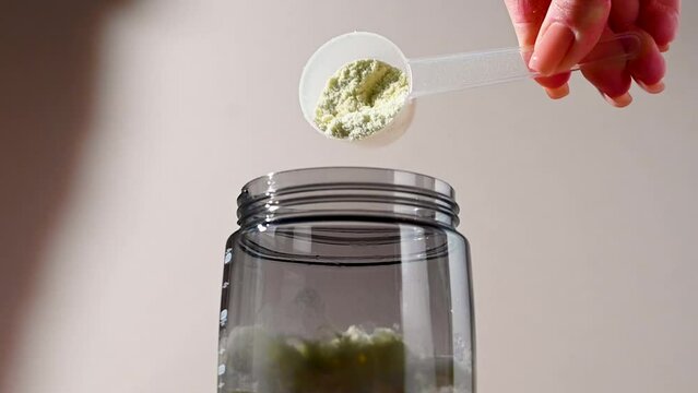 Protein shake and protein powder in a scoop, collagen, creatin, food supplement