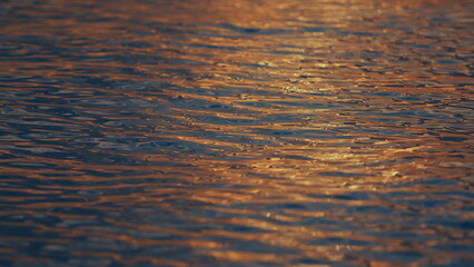 Water Surface Texture. Shiny Water With Sun Reflections. Rippled Water Texture Background Concept.