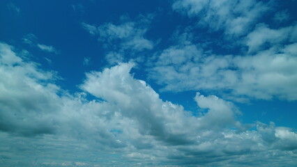 Nature Dark Blue Sky With Clouds Background. Bright Clear Skyline With Beautiful Cloudscape.