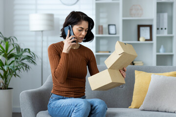 Woman on phone receiving wrong product delivery at home, feeling confused