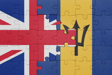 puzzle with the colourful national flag of barbados and flag of great britain.