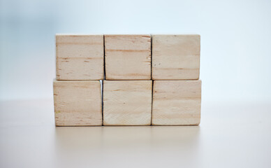 Health, insurance and wooden blocks on empty table in grey studio background for safety or security. healthcare logos, medicine and abstract block toys in a hospital design or clinic for medical care