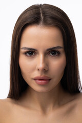 Beautiful young woman with clean perfect skin. Portrait of beauty model with natural nude make up and touching her face.