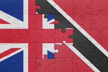 puzzle with the colourful national flag of trinidad and tobago and flag of great britain.