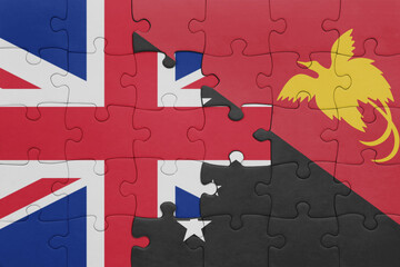 puzzle with the colourful national flag of Papua New Guinea and flag of great britain.