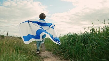 Happy israeli jewish little boy runs with Israel national flag. Independence Day. Patriotism.