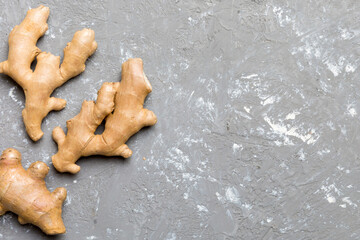 Finely dry Ginger powder in bowl with green leaves isolated on colored background. top view flat lay