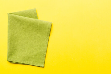 top view with green kitchen napkin isolated on table background. Folded cloth for mockup with copy space, Flat lay. Minimal style