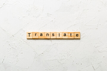 Translate word written on wood block. Translate text on cement table for your desing, concept