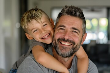 Fototapeta premium Close-up portrait of a father and son warmly embracing. Parenthood concept