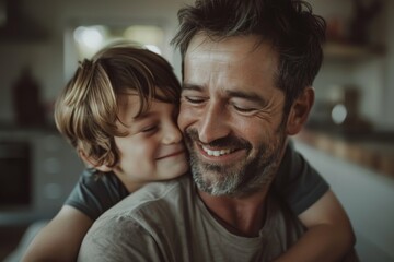 Close-up portrait of a father and son warmly embracing. Parenthood concept