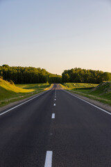 Fototapeta premium a colored sky at sunset and an empty highway