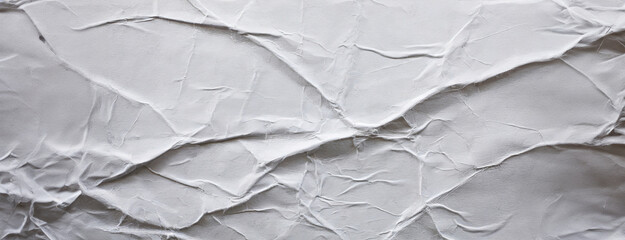 A crumpled white paper texture with visible folds and creases, providing a simple yet visually interesting background with a tactile quality.