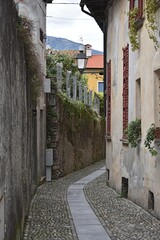 narrow stone street between houses in italy
