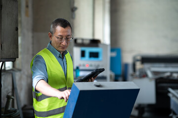 person working with tablet in workshop