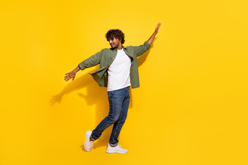 Portrait photo of young funny mexican guy have some fun chill out clubbing in khaki shirt isolated on yellow color background