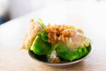 A plate of dumplings with a crispy crust and a soft, juicy filling.