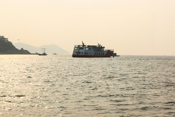 View of the fishing boat and the passenger boat on the sea in the afternoon