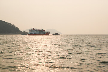 View of the fishing boat and the passenger boat on the sea in the afternoon