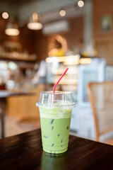 Iced green tea in a polystick glass on a donut in the beverage shop.