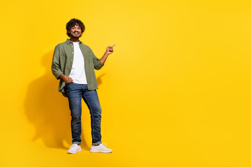 Portrait photo of young smiling promoter guy in khaki shirt recommend supermarket deals cheap...