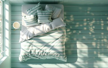 Comfortable striped bedding on wooden floor in modern bedroom interior with overhead view and natural lighting