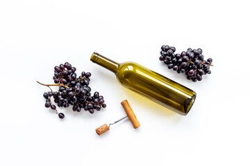 Open bottle of wine with cork and grapes. Wine background