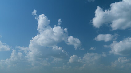 Summer clouds float across blue sky. Blue sky white clouds. Timelapse.