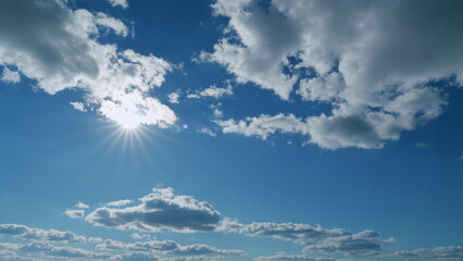 Beautiful scenic blue sky with rays of sun shining through clouds. Sun rays. Timelapse.