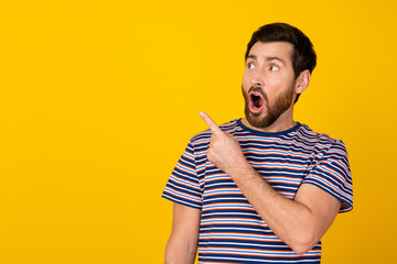 Photo of speechless man with stylish beard dressed striped t-shirt look directing at promo empty...