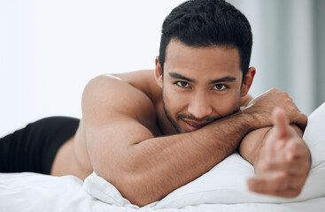 Happy, man and hand for welcome to bed in morning with blankets and pillows for romance or intimacy at home. Asian male person and model with smile, confidence and sexy greeting or gesture in bedroom