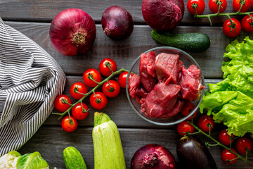 Cooking fresh vegetables with raw meat and herbs