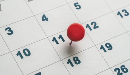 eleventh day of the month on the calendar marked with red pin