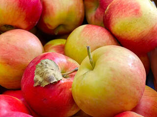 Ripe fresh bright red apples in close-up. Fresh fruits and vegetables. Proper nutrition, vitamins and trace elements. Fruits are rich in iron. Supermarkets and shops. Food products. Photo.