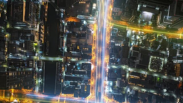 Vibrant hyper lapse of huge city at night with data visualization overlays, showcasing city traffic patterns and infrastructure highlights