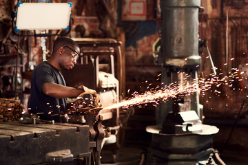 Blacksmith, factory or black man in workshop and sparks, manual labor for safety on hot steel with flash or welder. Metal work, person welding or iron tools for manufacturing craft, trade and plant