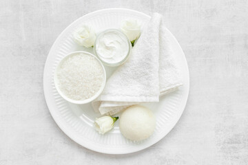 White cosmetics products with stones and white roses