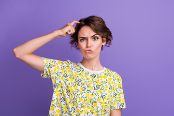 Portrait of pretty young woman scratch head empty space wear t-shirt isolated on purple color...