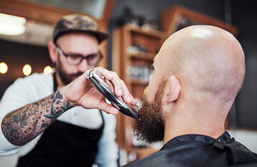 Beard, hair care and man in barbershop with machine, cut and tools for trendy facial shave at small...