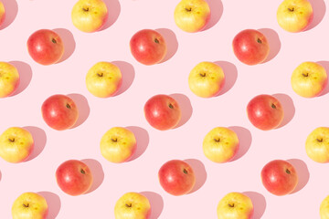  A shiny apple against an isolated pastel pink background, minimal healthy fruits idea on pink background. Apple fruit pattern.