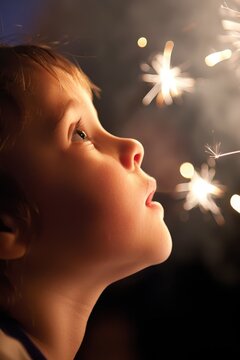 A child's eyes widening in amazement as they watch a fireworks display light up the night sky.