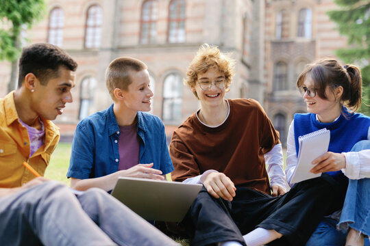 Joyful students sharing ideas on university grounds