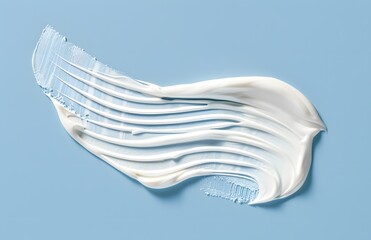 Creamy cosmetic texture smear on a vibrant blue backdrop