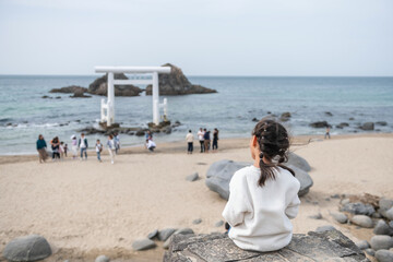 girl view Sakurai Futamigaura couple stones and torii gate, Itoshima