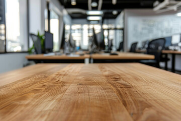 A wooden tabletop in the foreground with a blurred background of a high-tech office. The background features modern workstations with multiple monitors, ergonomic chairs, and whiteboards.
