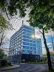 office building with sun in windows © Adam
