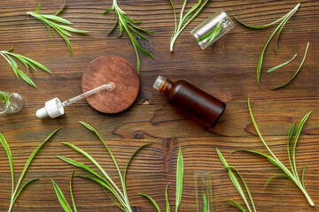 Medicinal herbs with natural cosmetics essential oil in bottle, top view